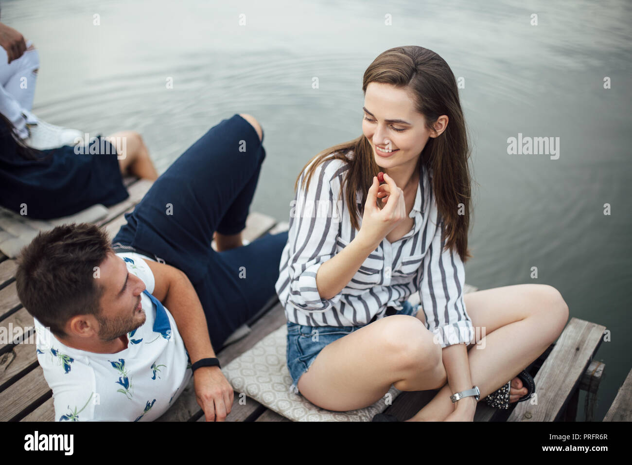 Young pretty woman flirting with handsome man while relax on river. Summer vacation Stock Photo