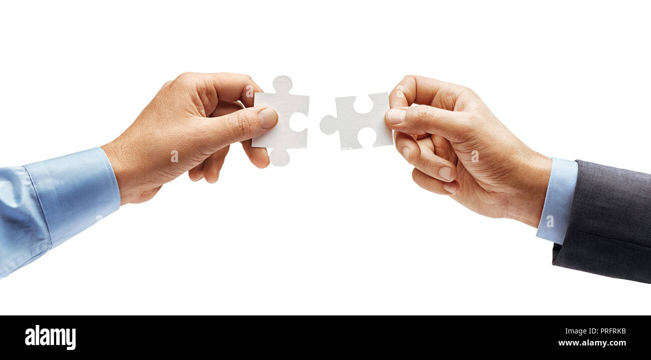 Man's hand in shirt and man's hand in suit trying to connect puzzle pieces isolated on white background. Close up. High resolution product Stock Photo