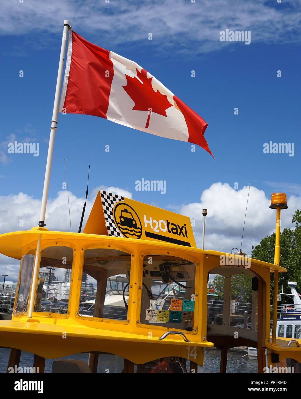 Harbour ferry and Canadian Flag , Inner Harbour, Victoria, Vancouver Island. Stock Photo