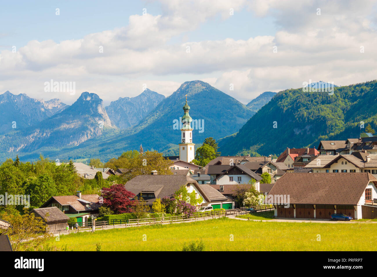 Alpine village St. Gilgen with a church, mountains on background ...