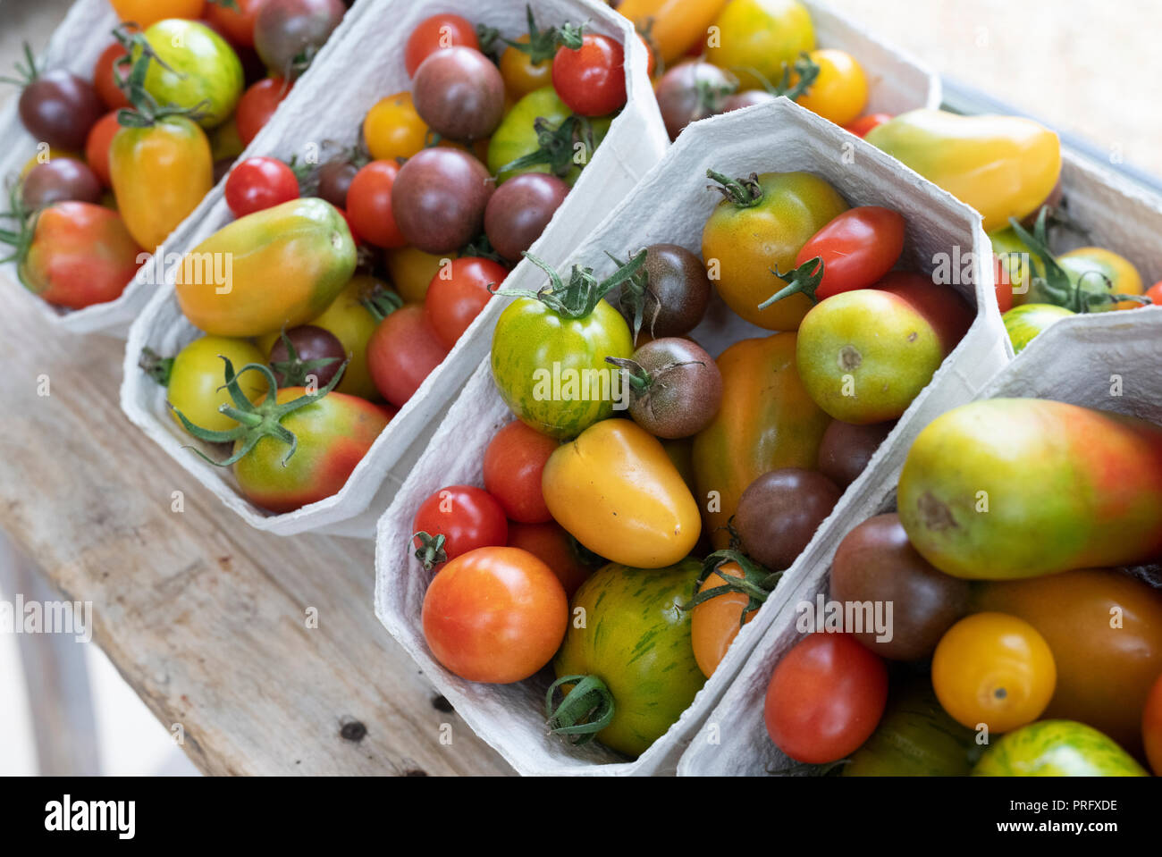 Punnets of heritage tomatoes at Daylesford Organic farm shop autumn festival. Daylesford, Cotswolds, Gloucestershire, England Stock Photo
