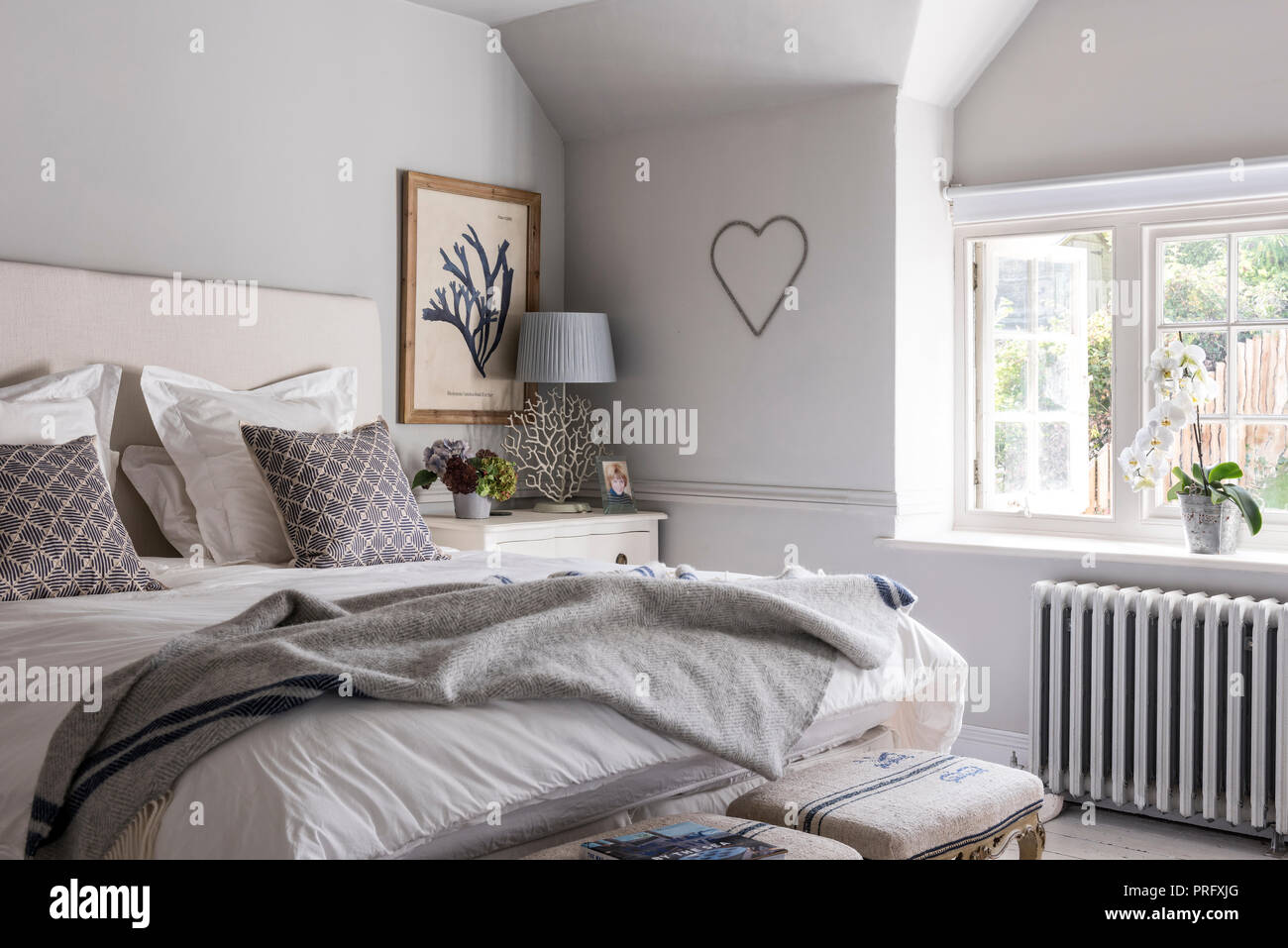 Unmade bed in room with heart,  Devon cottage Stock Photo