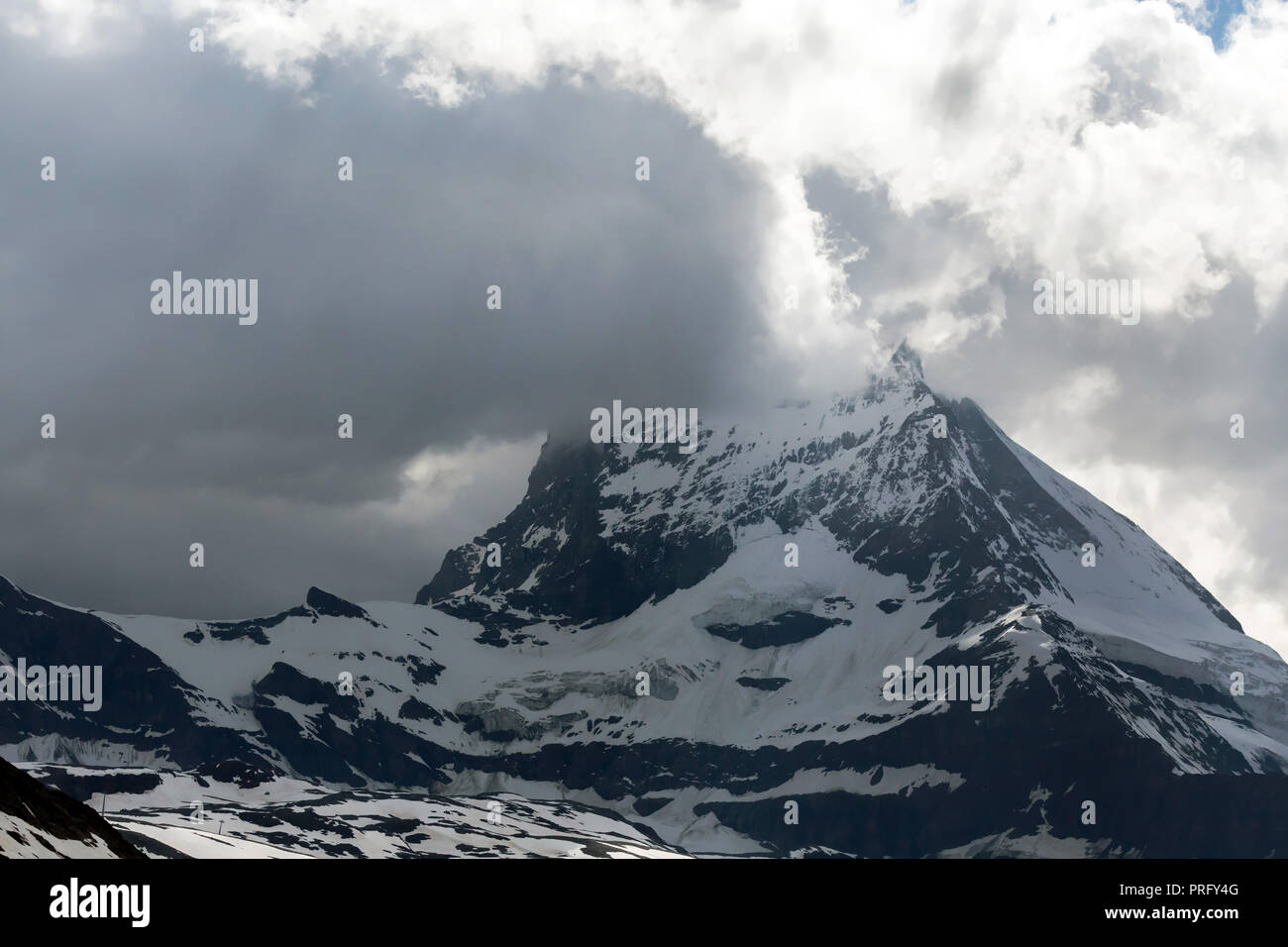 View of  Matterhorn peak above clouds, Pennine Alps, Switzerland. Stock Photo