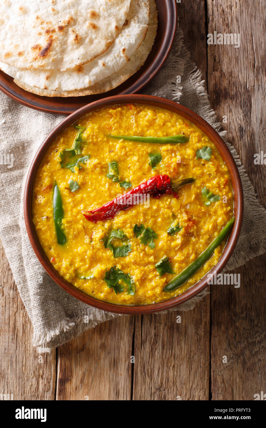 Indian popular food Dal Tadka Curry served with roti flatbread close-up on  the table. Vertical top view from above Stock Photo - Alamy