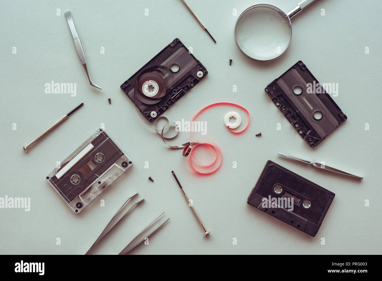 Flat lay audio cassette parts on pastel blue background, top view of retro technology and media concept Stock Photo