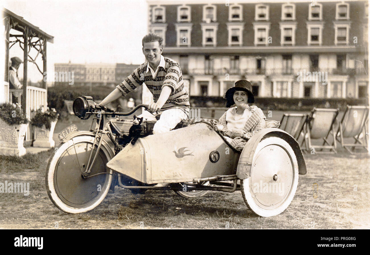 Young man and young lady on a 1920 New Gerrard motorcycle & sidecar combination at the seaside circa 1920 Stock Photo