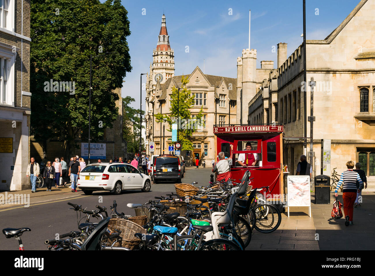 View down St Andrews Street with bicycles parked and people walking around, Cambridge, UK Stock Photo