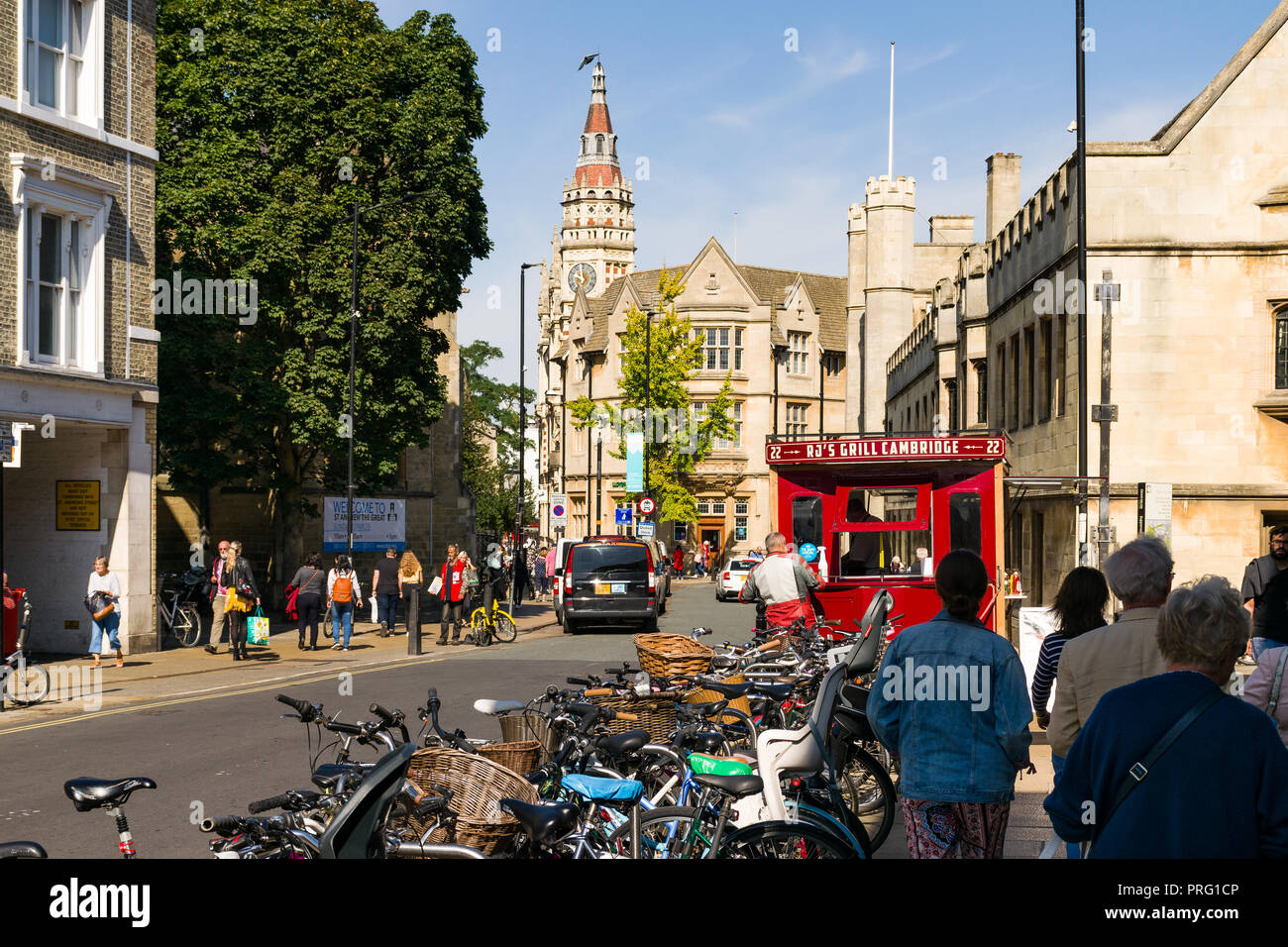 View down St Andrews Street with bicycles parked and people walking around, Cambridge, UK Stock Photo
