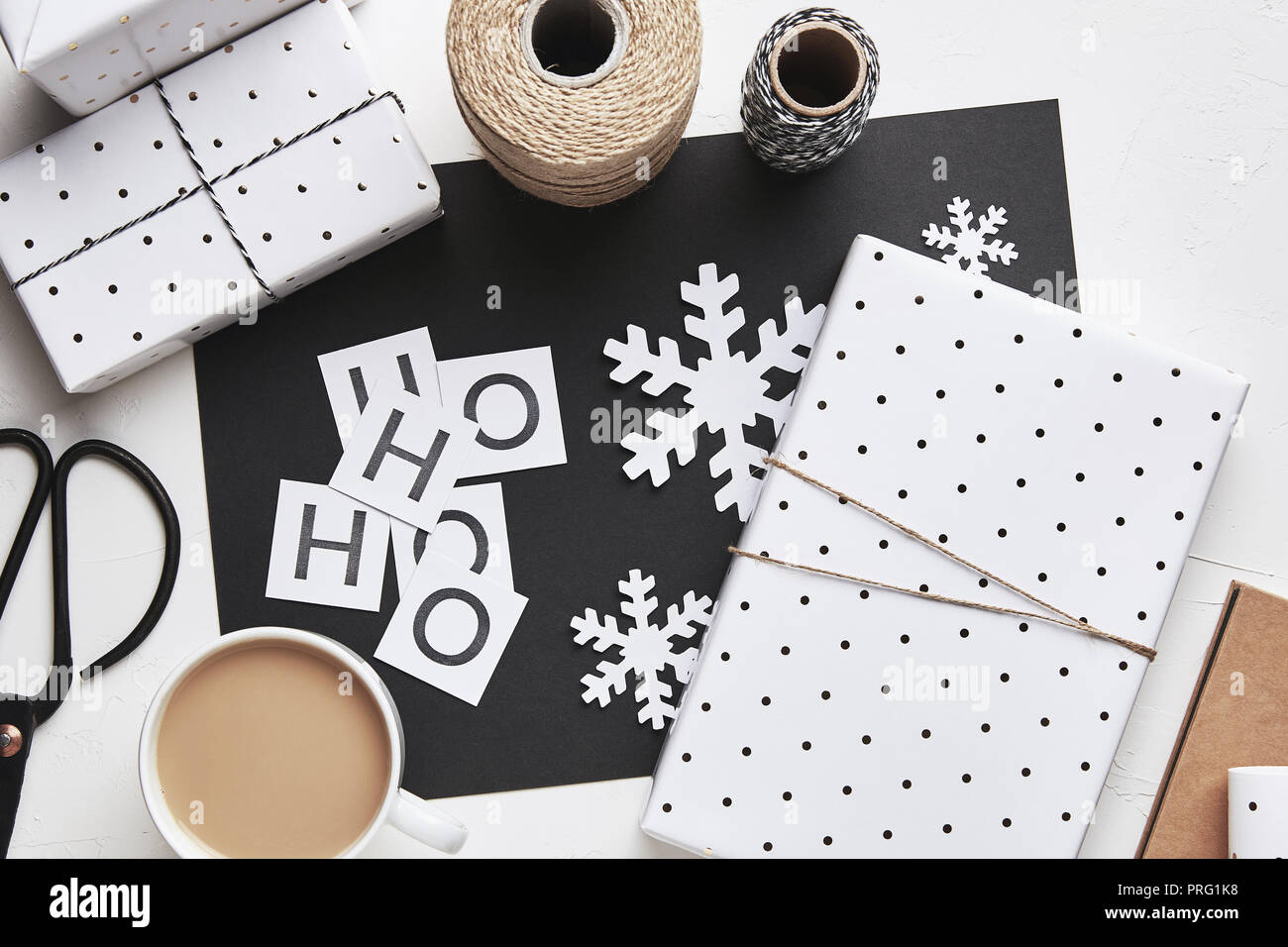 Flat lay Christmas composition with gift boxes and snowflakes in black ...