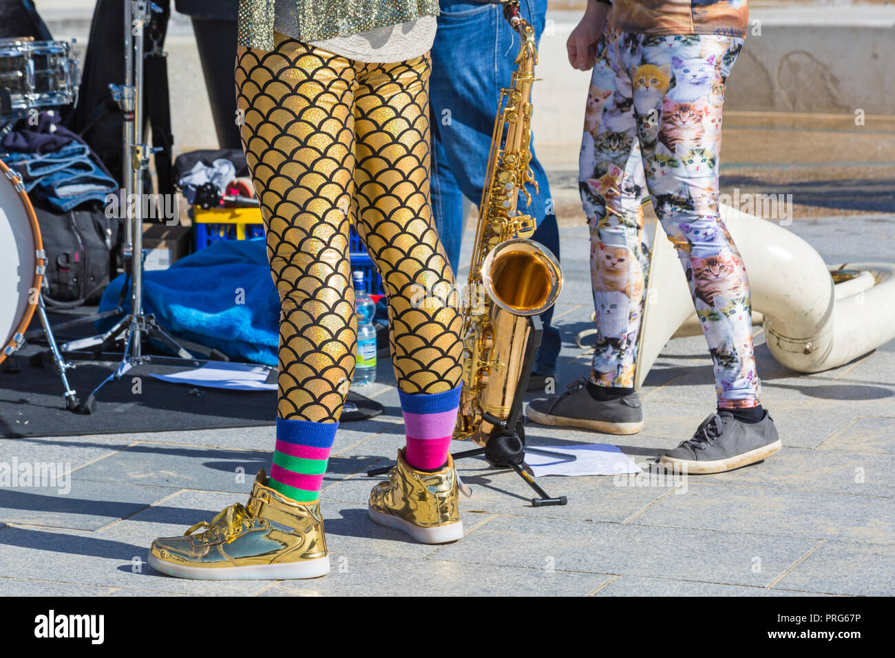 Musician's leggings - members of Tuba Libres group wearing gold leggings and boots & cat leggings at Bournemouth Arts by the Sea Festival Stock Photo