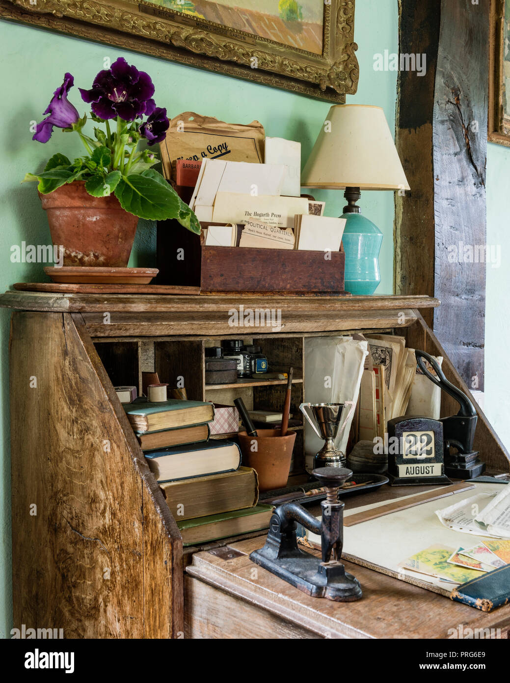 Letter rack and houseplant on writing desk in cottage, once home to Virgina Wolfe Stock Photo