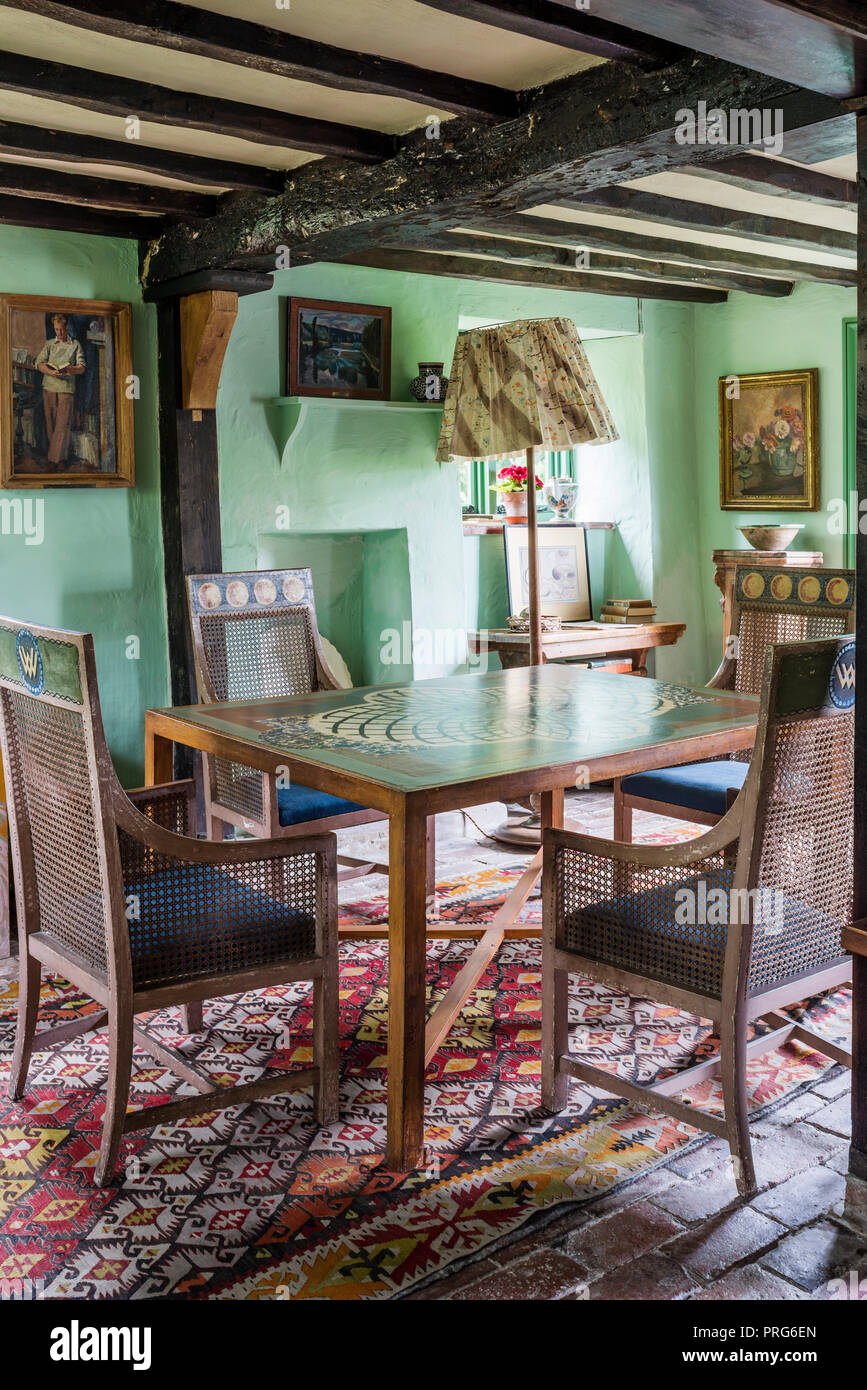Cane chairs at hand-painted table in cottage, once home to Virginia Wolfe Stock Photo