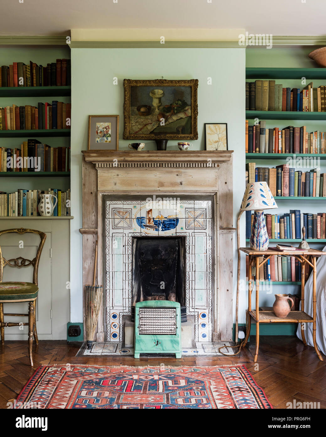 Bookshelves and fireplace in cottage, once home to Virgina Wolfe Stock Photo