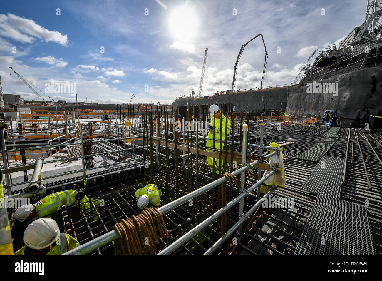 Construction workers fit reinforced concrete steel bars close to where the nuclear reactor will be housed at the EDF Energy Hinkley Point C nuclear power station in Somerset. . Stock Photo