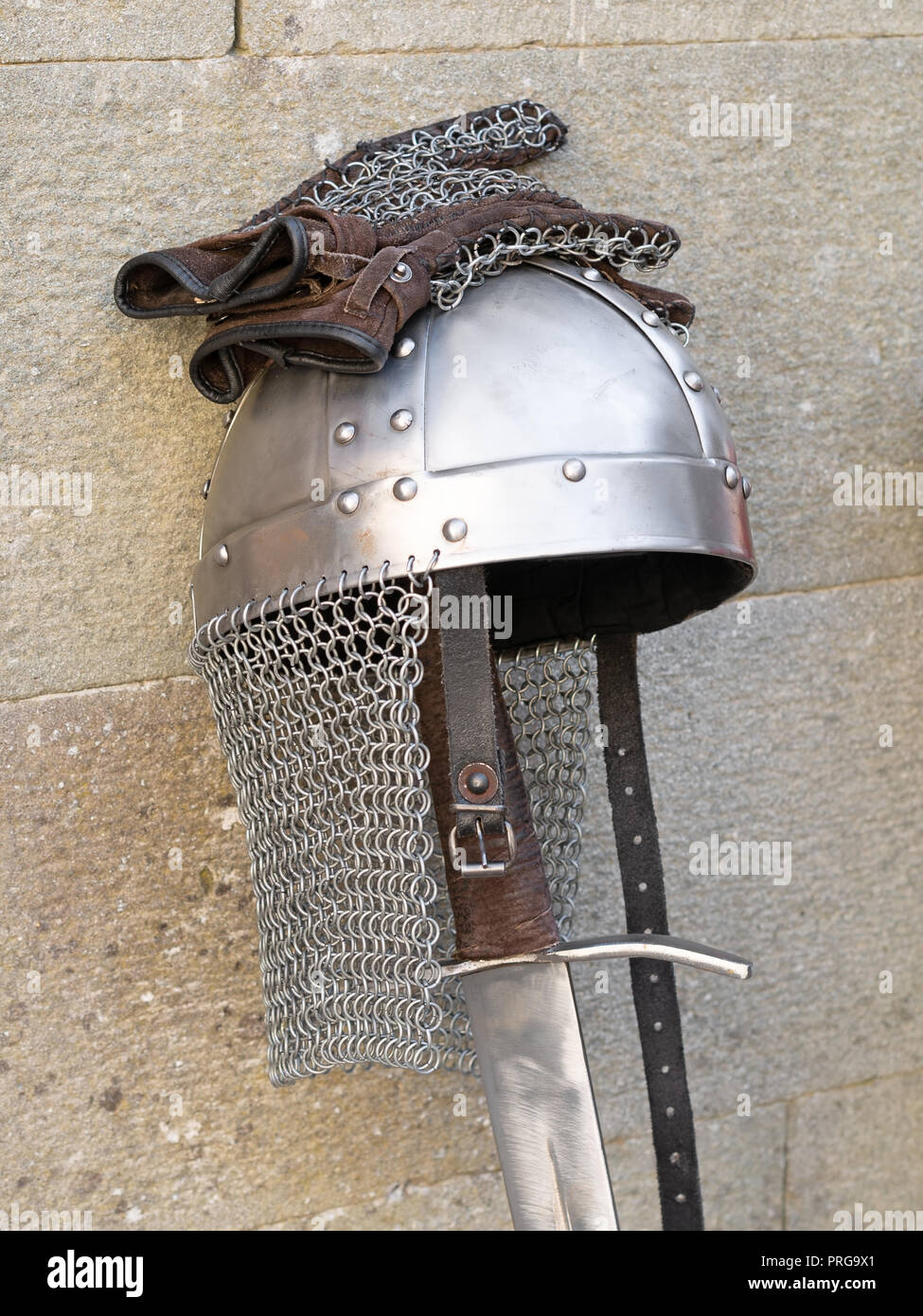 Medieval swords, knight helmet and chain mail gloves. Stock Photo