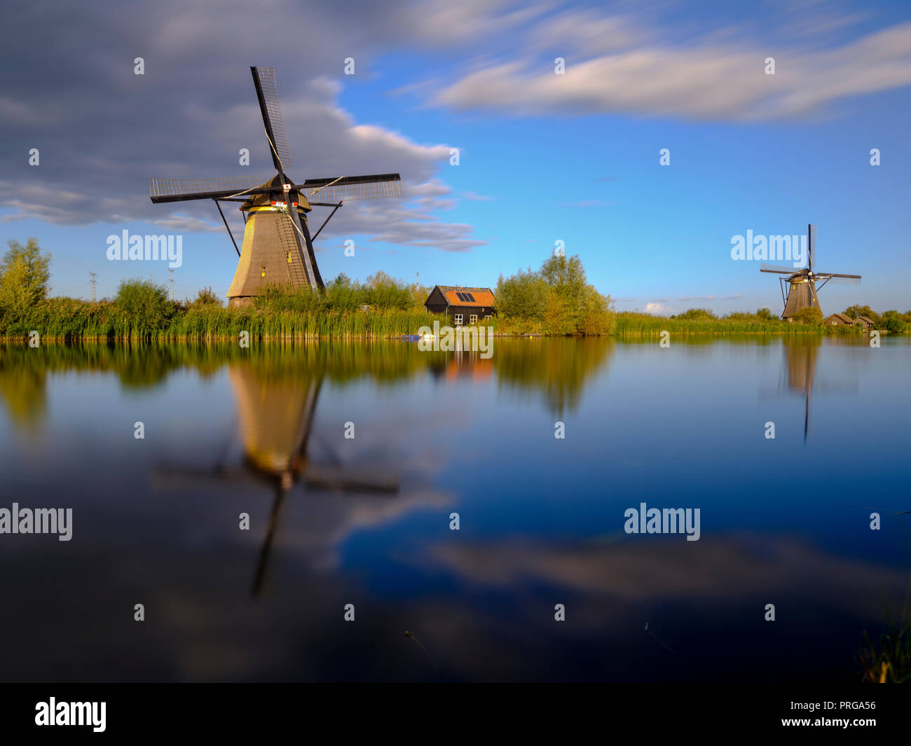 Autumn golden hour light on the windmills, canals and polders of Kinderdijk, near Rotterdam, Netherlands Stock Photo