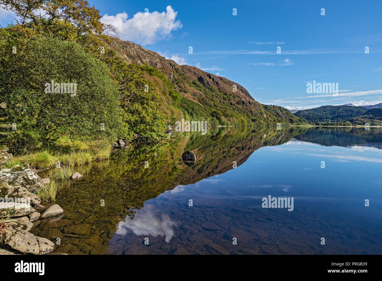 Reflections in Llyn Dinas in the Nant Gwynant valley near Beddgelert Snowdonia National Park North Wales UK September 0836 Stock Photo