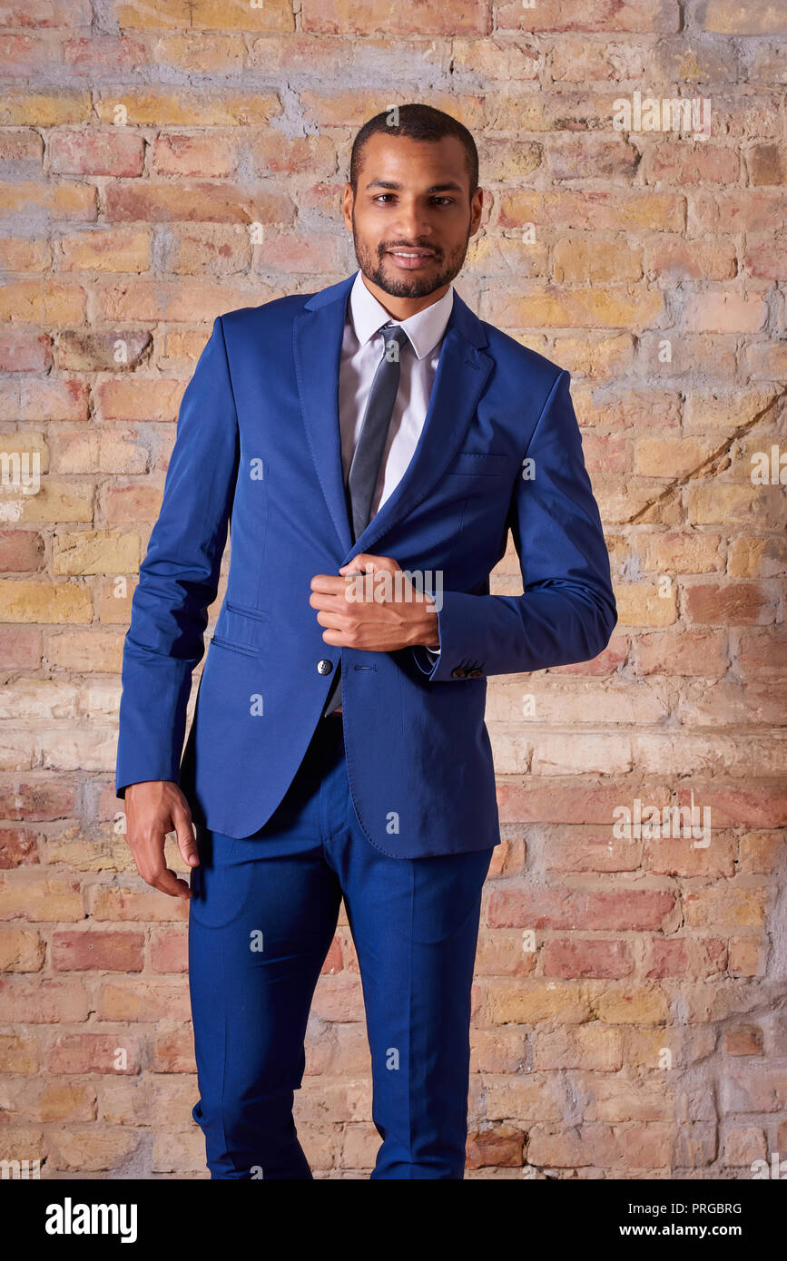 Portrait of a happy handsome young businessman in a suit Stock Photo ...