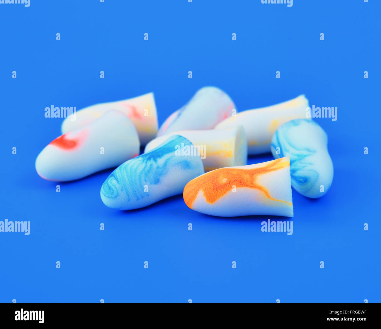 several earplugs on a blue background Stock Photo