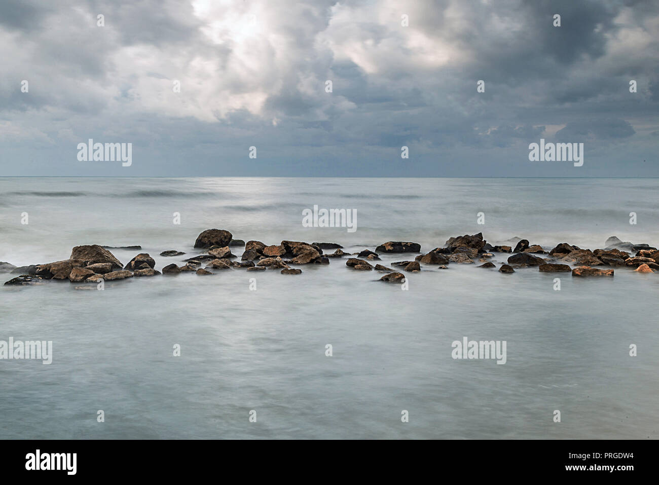 A photo of Long exposure shot of seascape with beautiful rock at the horizon. A Gaza,Palestine. Stock Photo