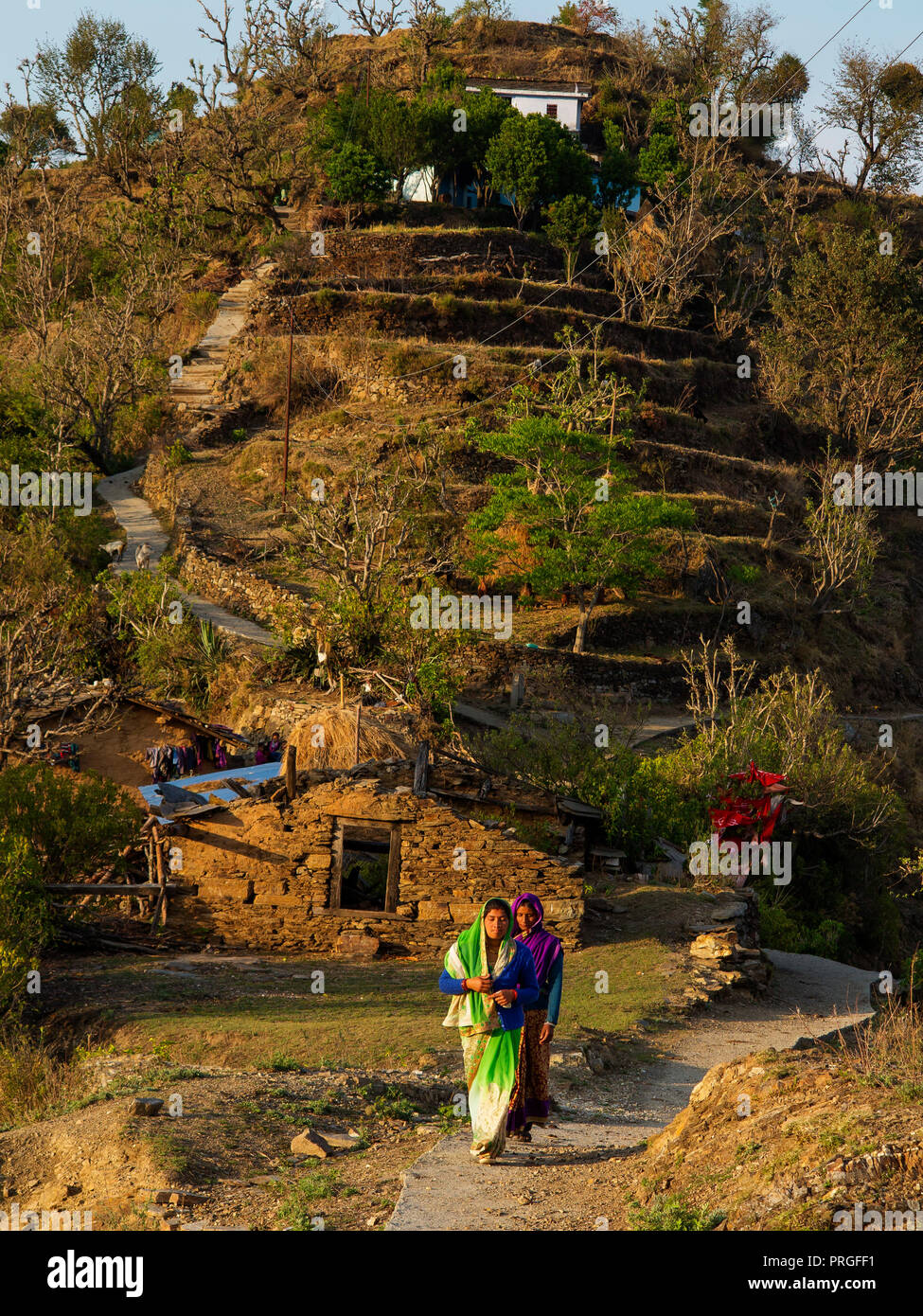 Indian womans walking on 'the saddle' at the remote Tulla Kote Village on the Tallas Des area, Kumaon Hills, Uttarakhand, India Stock Photo