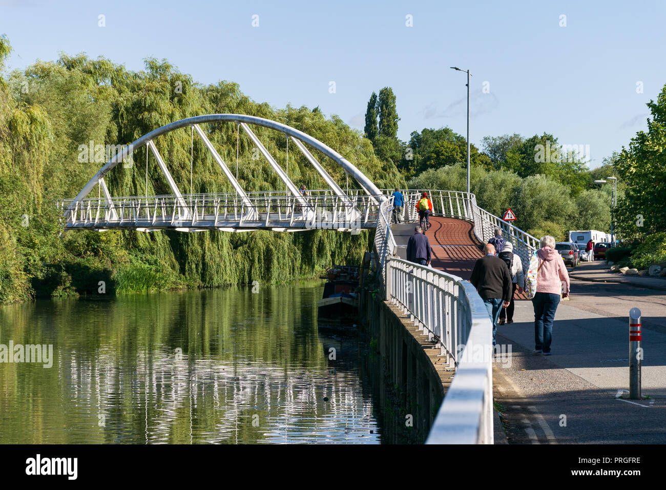 The pedestrian Riverside Bridge across the river Cam with people walking and cycling across it, cambridge, UK Stock Photo