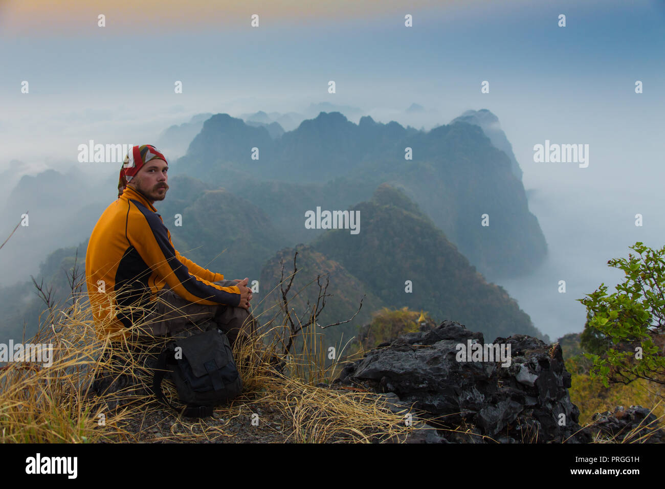 Man sitting on top mountain hi-res stock photography and images - Alamy