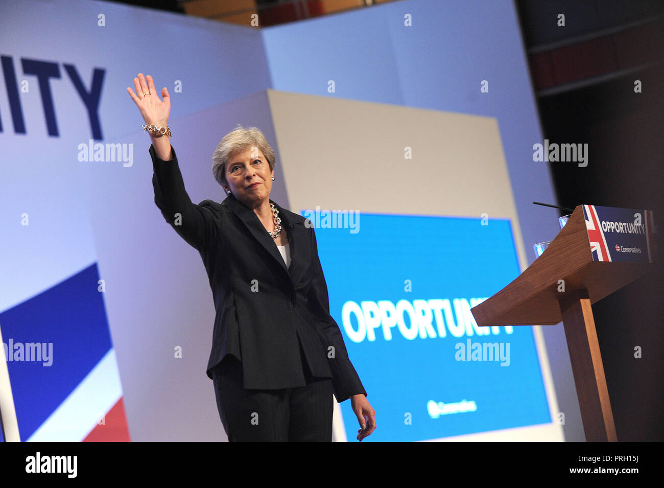 Birmingham, England. 3rd October, 2018.  Theresa May MP, Prime Minister and Leader of the Conservative Party, waves to the audience following her keynote speech to conference on the closing session of the fourth day of the Conservative Party annual conference at the ICC.  Kevin Hayes/Alamy Live News Credit: Kevin Hayes/Alamy Live News Stock Photo