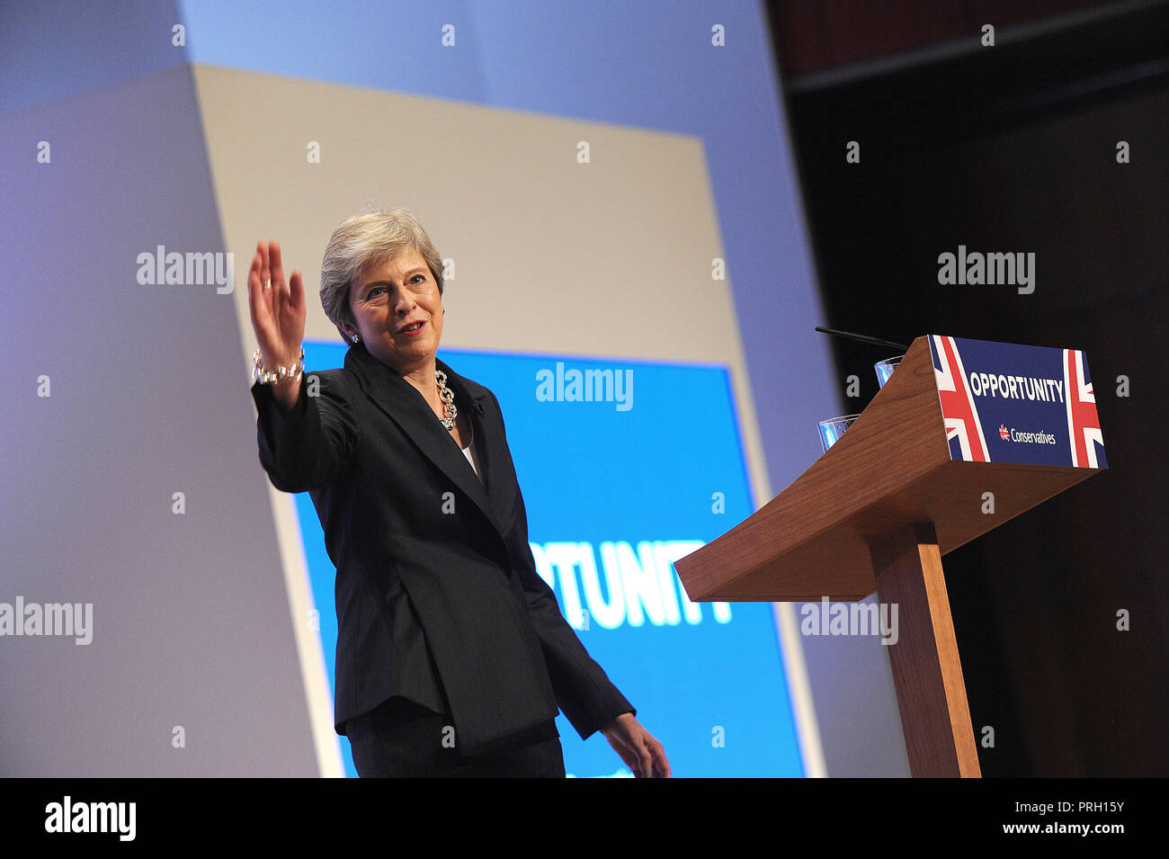 Birmingham, England. 3rd October, 2018.  Theresa May MP, Prime Minister and Leader of the Conservative Party, waves to the audience following her keynote speech to conference on the closing session of the fourth day of the Conservative Party annual conference at the ICC.  Kevin Hayes/Alamy Live News Credit: Kevin Hayes/Alamy Live News Stock Photo