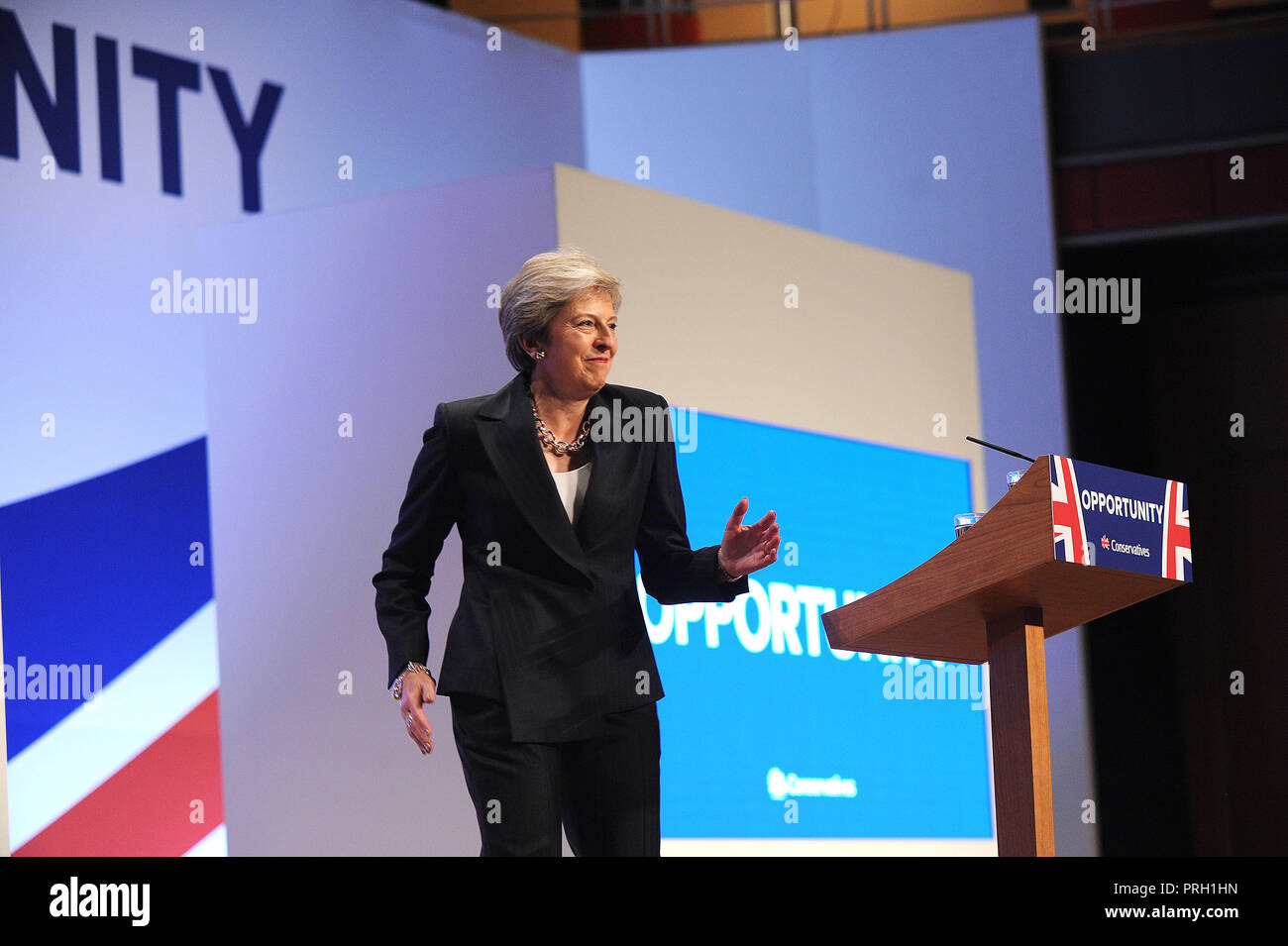 Birmingham, England. 3rd October, 2018.  Theresa May MP, Prime Minister and Leader of the Conservative Party, dances onto stage to deliver her keynote speech to conference on the closing session of the fourth day of the Conservative Party annual conference at the ICC.  Kevin Hayes/Alamy Live News Credit: Kevin Hayes/Alamy Live News Stock Photo