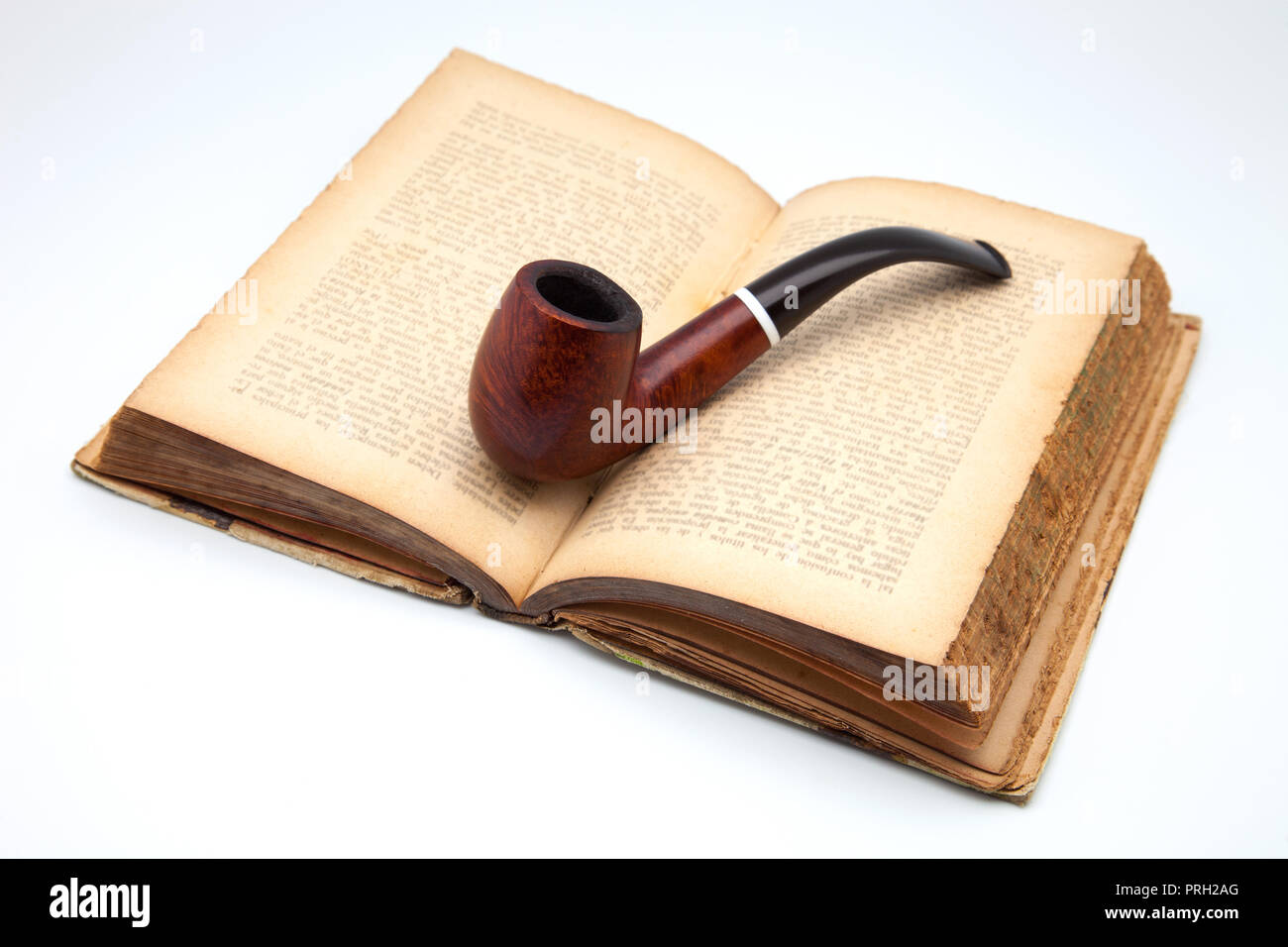 wooden pipe on open book Stock Photo Alamy