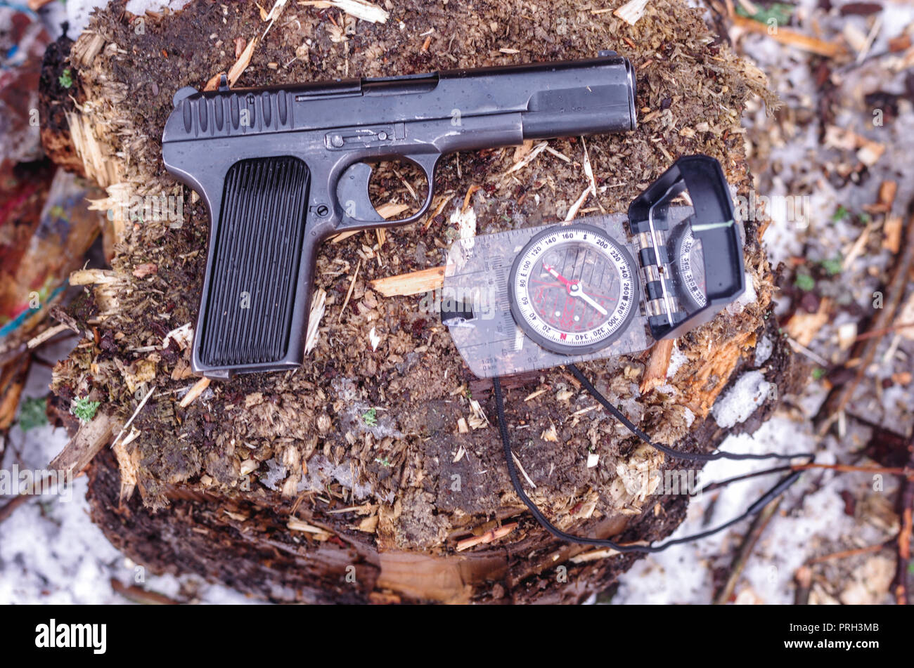 Service pistol and compass. Rescue kit. Flat lay. Top. Stock Photo