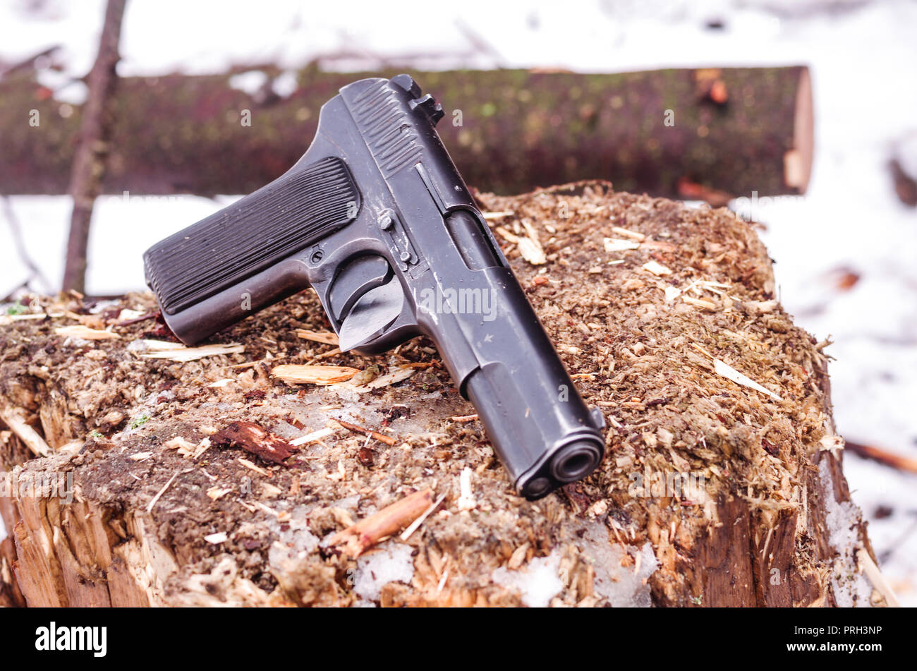 Black pistol tilted. Photo of the gun at an angle. Front view. Stock Photo