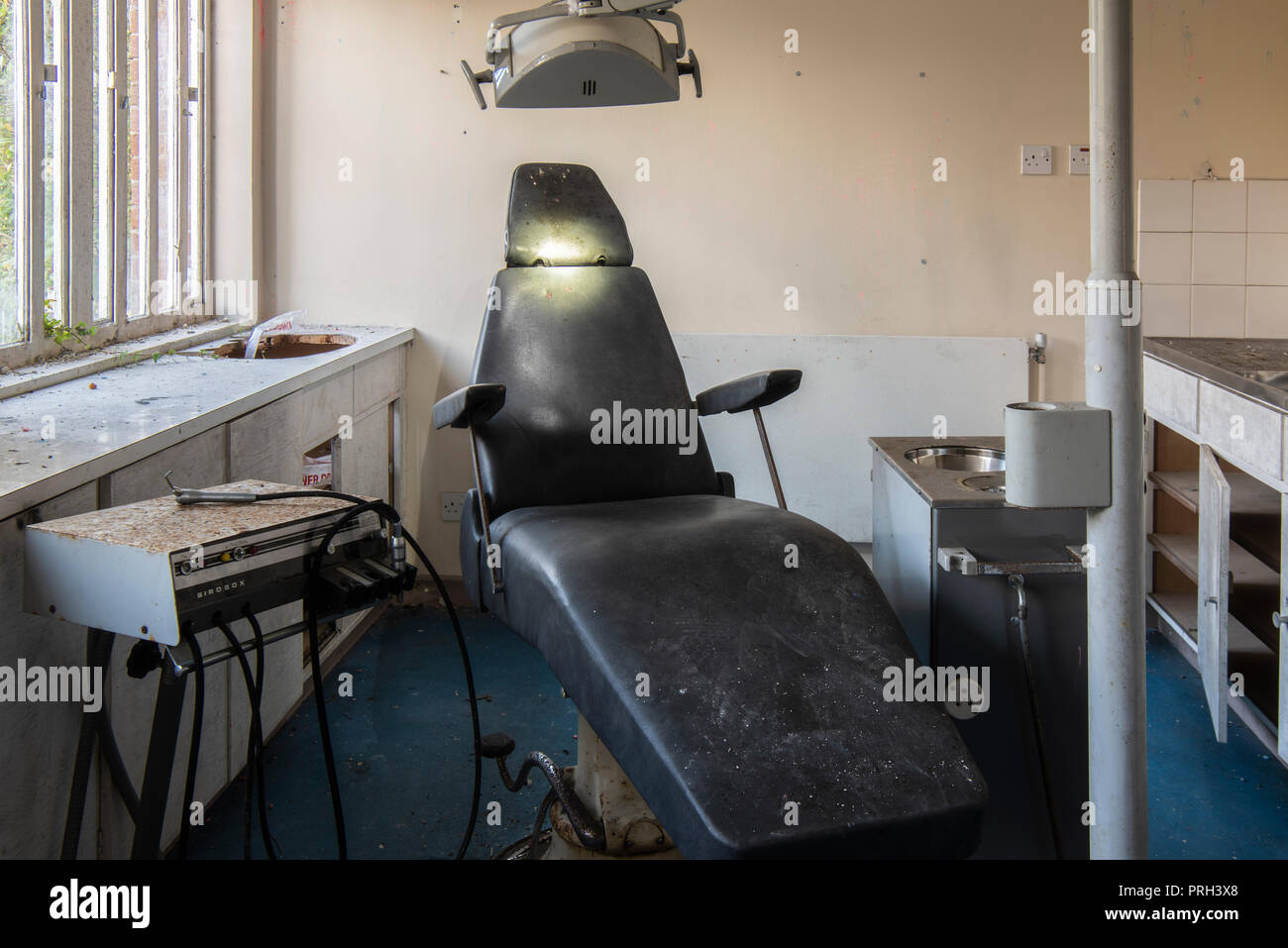 Dentists chair, suction and drill machine, inside a prison dentist room. Stock Photo