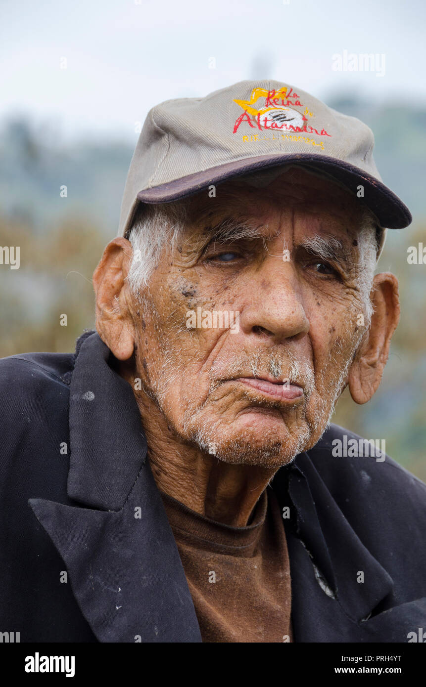 An older man with vision problems waits for public transport which is scarce in rural areas. Stock Photo