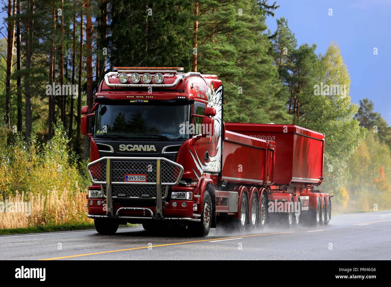 Salo, Finland - September 28, 2018: Red Scania R730 truck and gravel trailer for limestone haul of R Aalto on wet road in autumn in South of Finland. Stock Photo