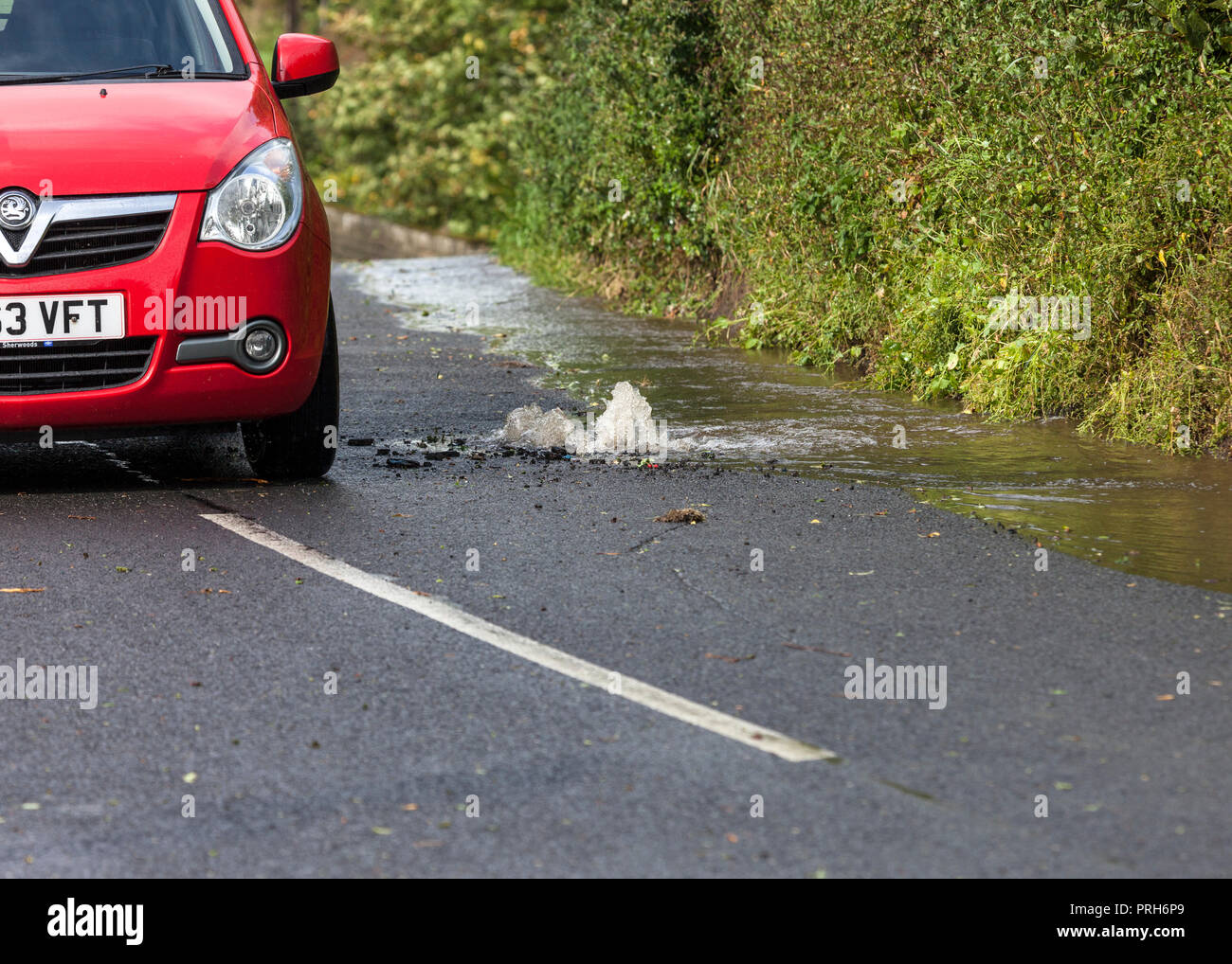 A Car Driving Around a Burst Water Main, Teesdale, County Durham, UK Stock Photo