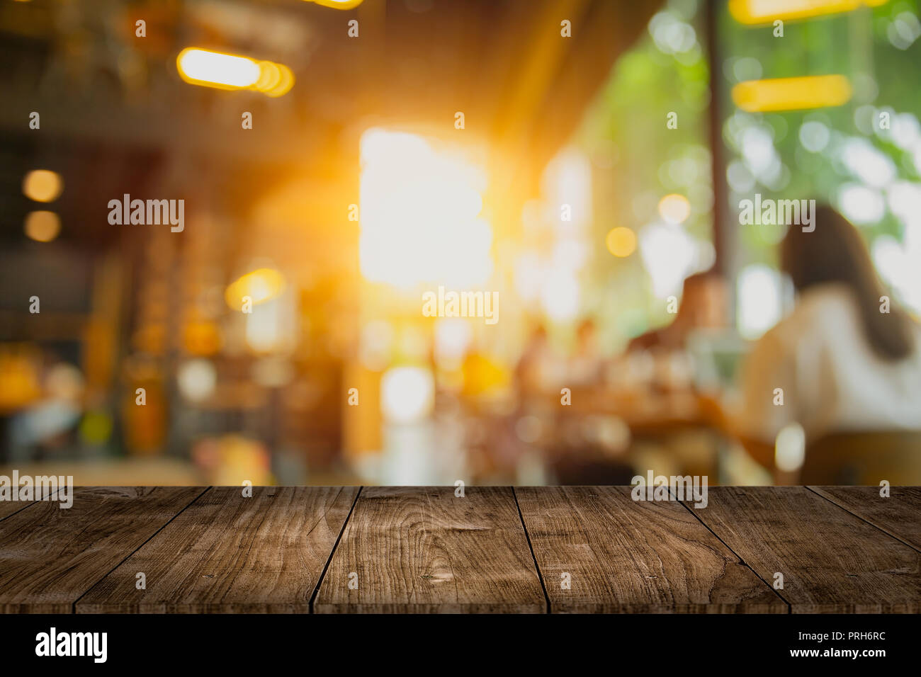 wooden table top blank space with cafe interior blur design for ...