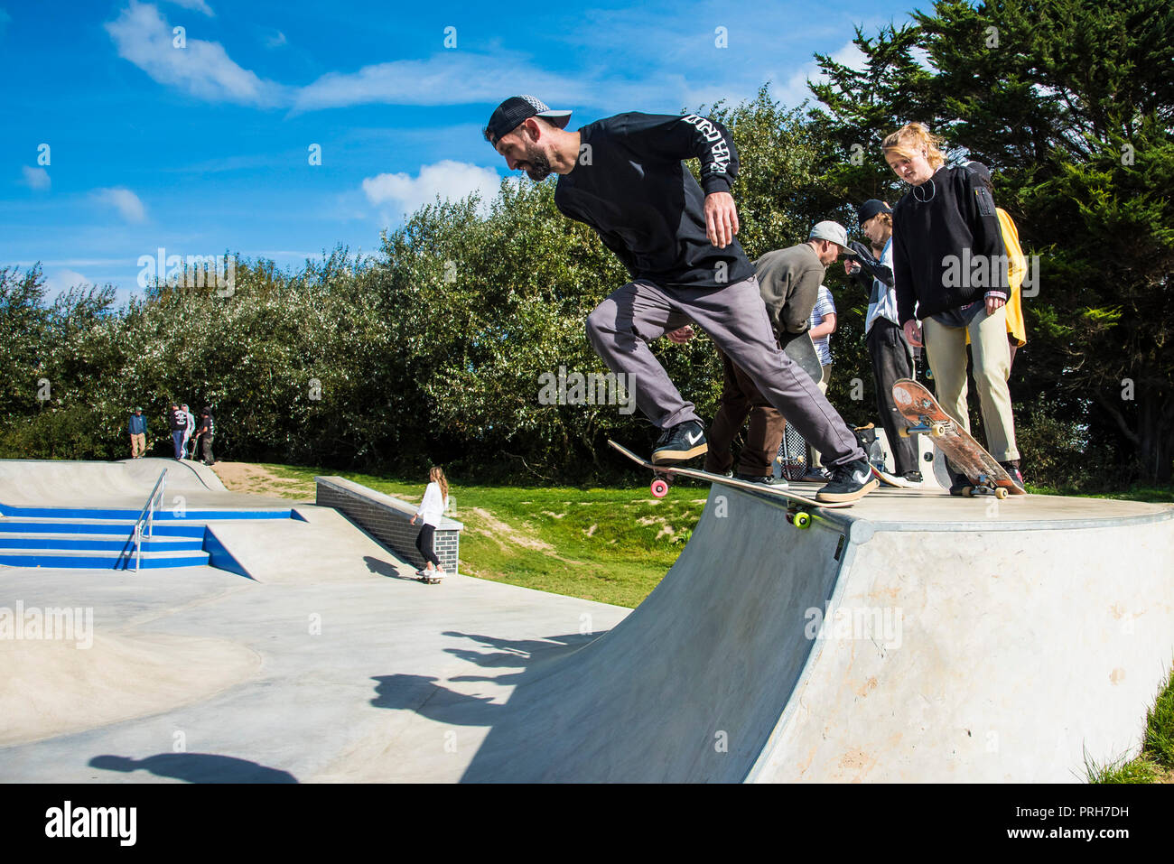 A skateboarder pushing off from a deck at Concrete Waves in Newquay in Cornwall. Stock Photo