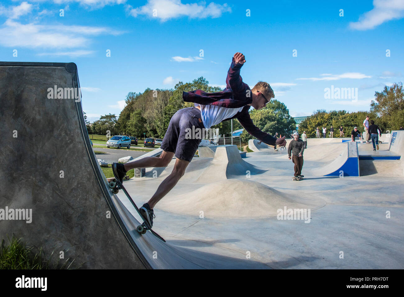 A skateboarder performing a skateboarding trick on a quarter pipe at