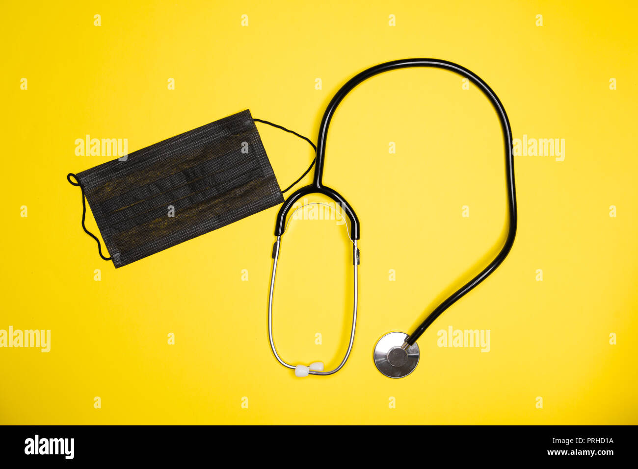 Medical wearable black sterile face mask with stethoscope. Concept clinic tools theme Stock Photo
