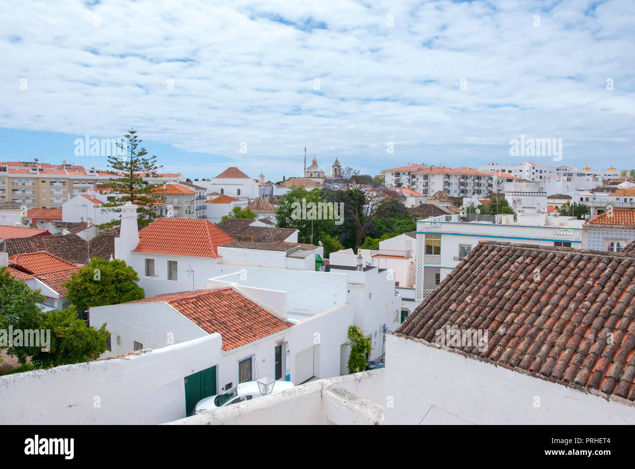 Tiled Rooftops of Tavira City The Algarve Portugal elevated cityscape view from 12th century tavira castle across the red reddish brown tiles of the r Stock Photo