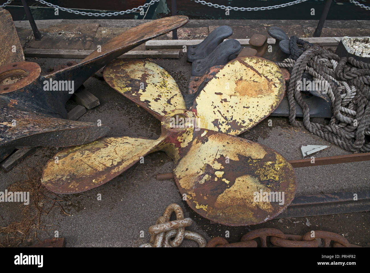 Propeller, rope, and chain lying on quayside near SS Great Britain