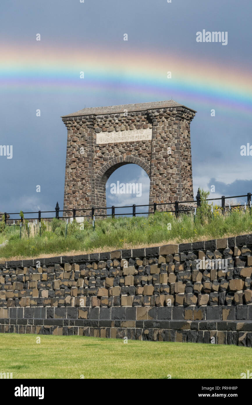 Rainbow over the Roosevelt Arch at the north entrance to Yellowstone National Park. Stock Photo