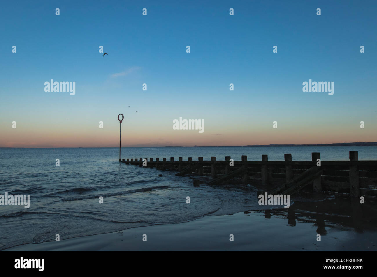 Old wooden Groyne on Portobello beach at sunset, Edinburgh Scotland