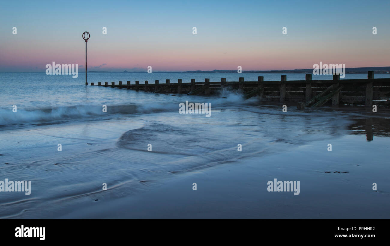 Old wooden Groyne on Portobello beach at sunset, Edinburgh Scotland Stock Photo