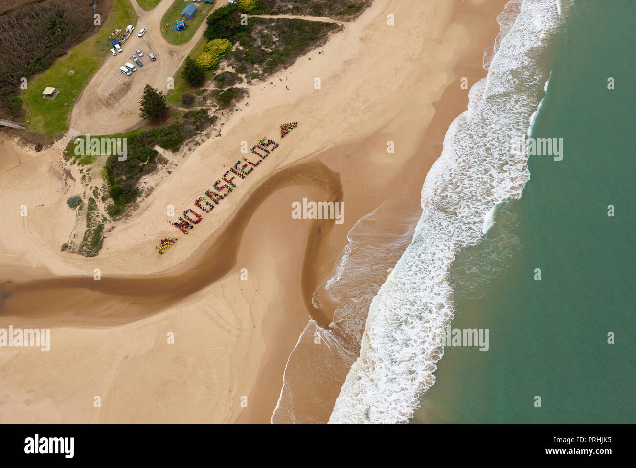 Locals protest proposed coal seam gas developments via a 'No Gasfields' human sign on the beach at Seaspray in Gippsland, Australia. Stock Photo