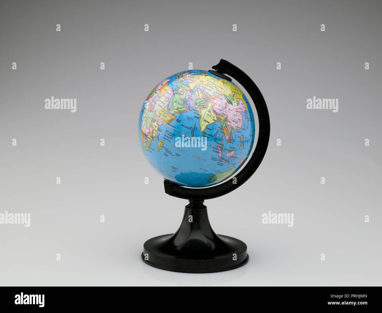 STILL LIFE OF A GLOBE DEPICTING THE EARTH ON A WHITE BACKGROUND Stock Photo