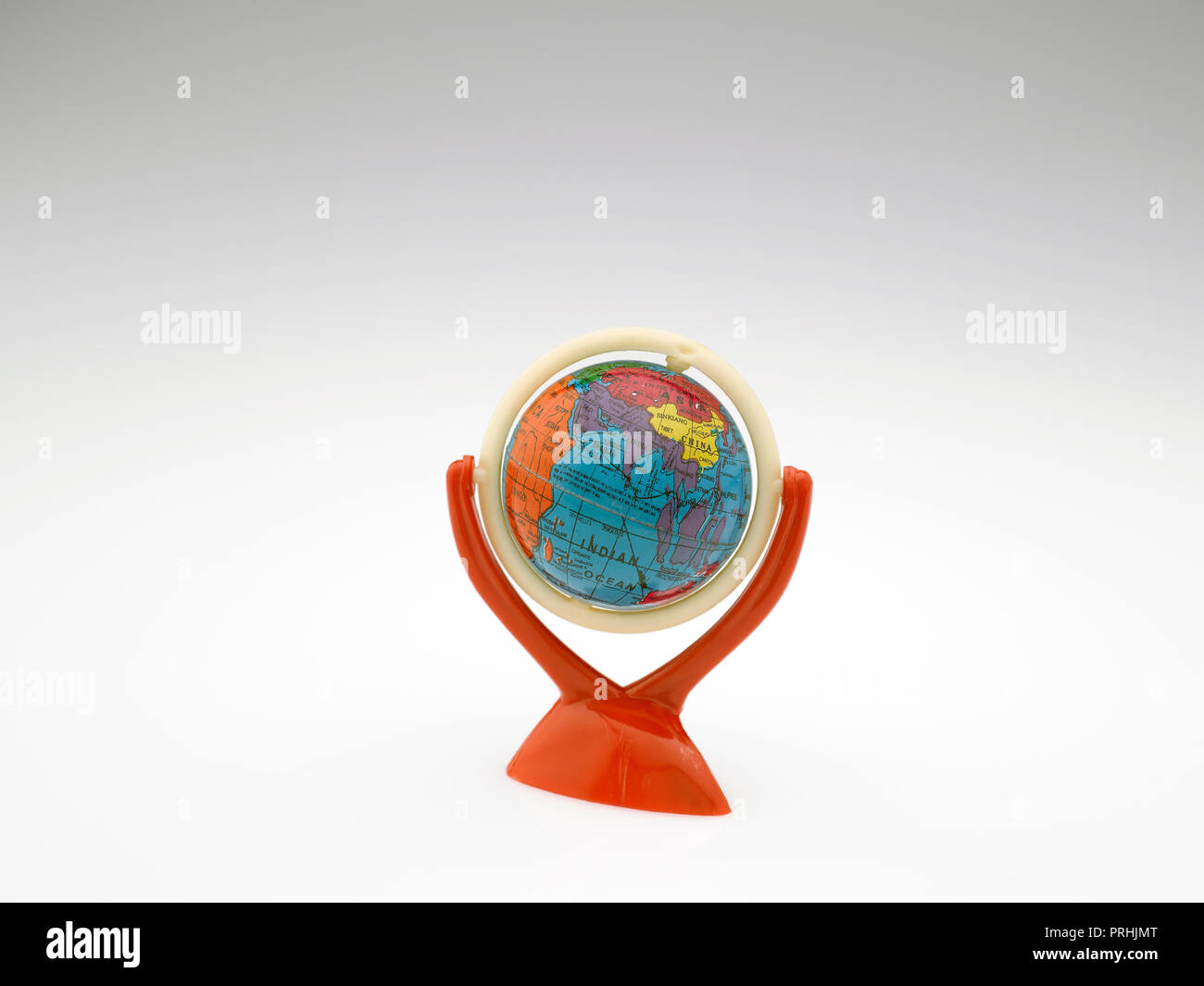 STILL LIFE OF A GLOBE DEPICTING THE EARTH ON A WHITE BACKGROUND Stock Photo