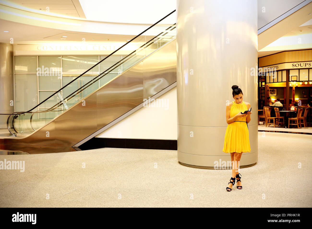 Houston, Usa - June 20, 2018: Unidentified lady in yellow reading in the Underground city in Houston, Texas Stock Photo